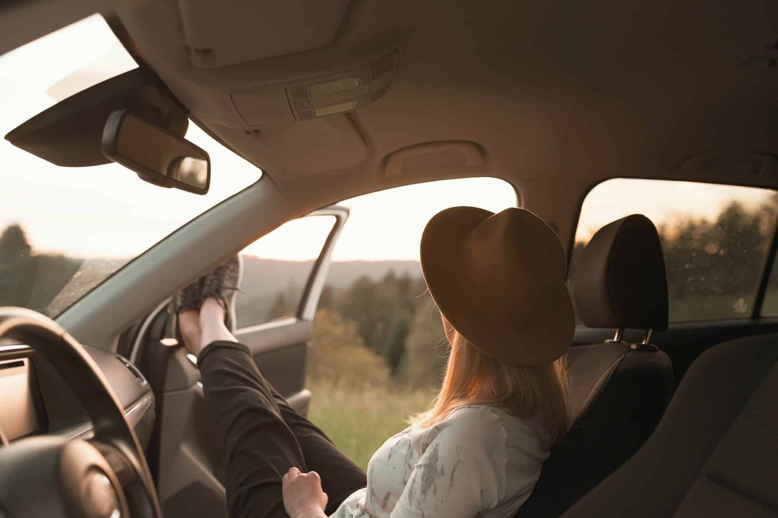 Back view of young woman on a road trip